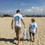 dad and child beach cleanup